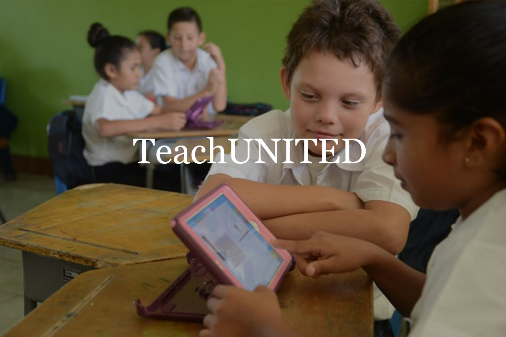 Teach United - one boy and one girl in school uniform looking at a tablet.